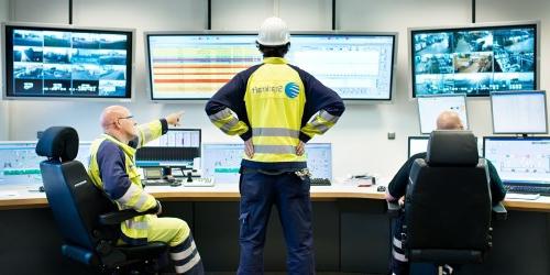 Three Workers at Central Control Room in Knapsack